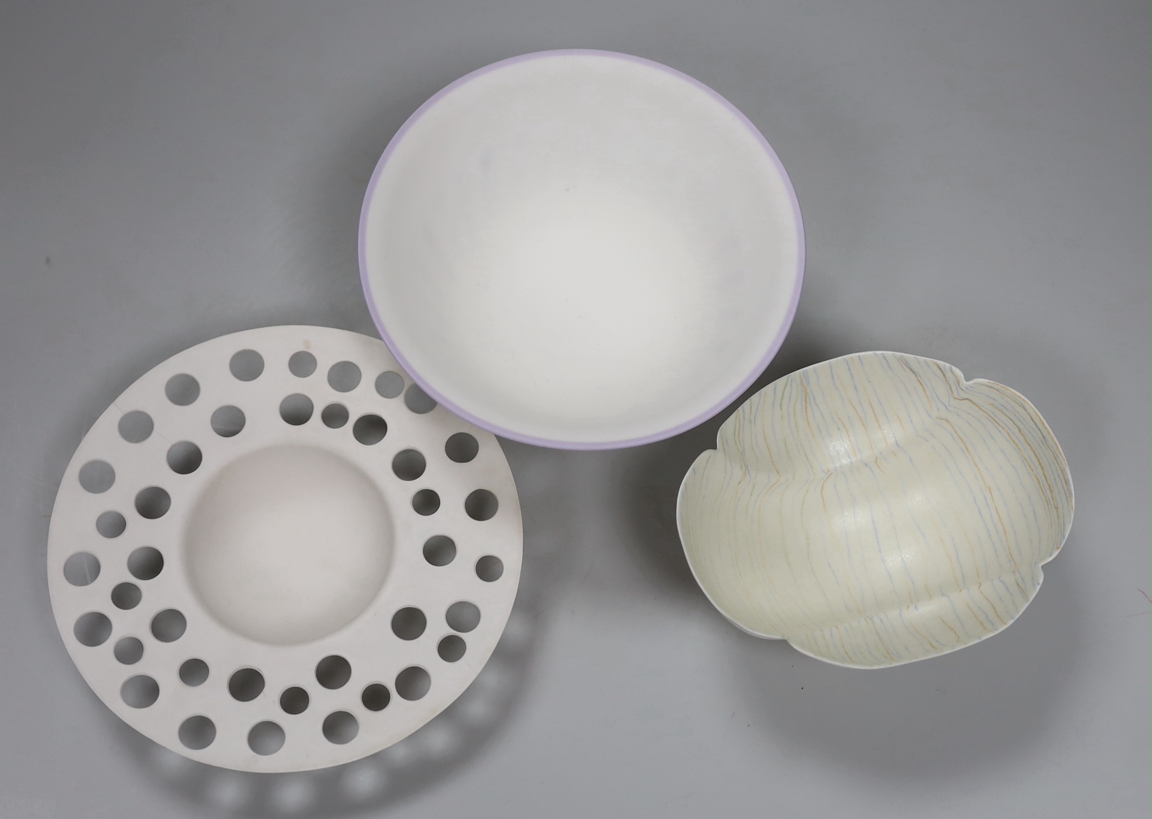Three bone china studio bowls, one with pierced decoration, the largest 14.5cm in diameter